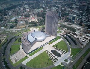 a modern, circular, multi-level building surrounded by a meticulously landscaped